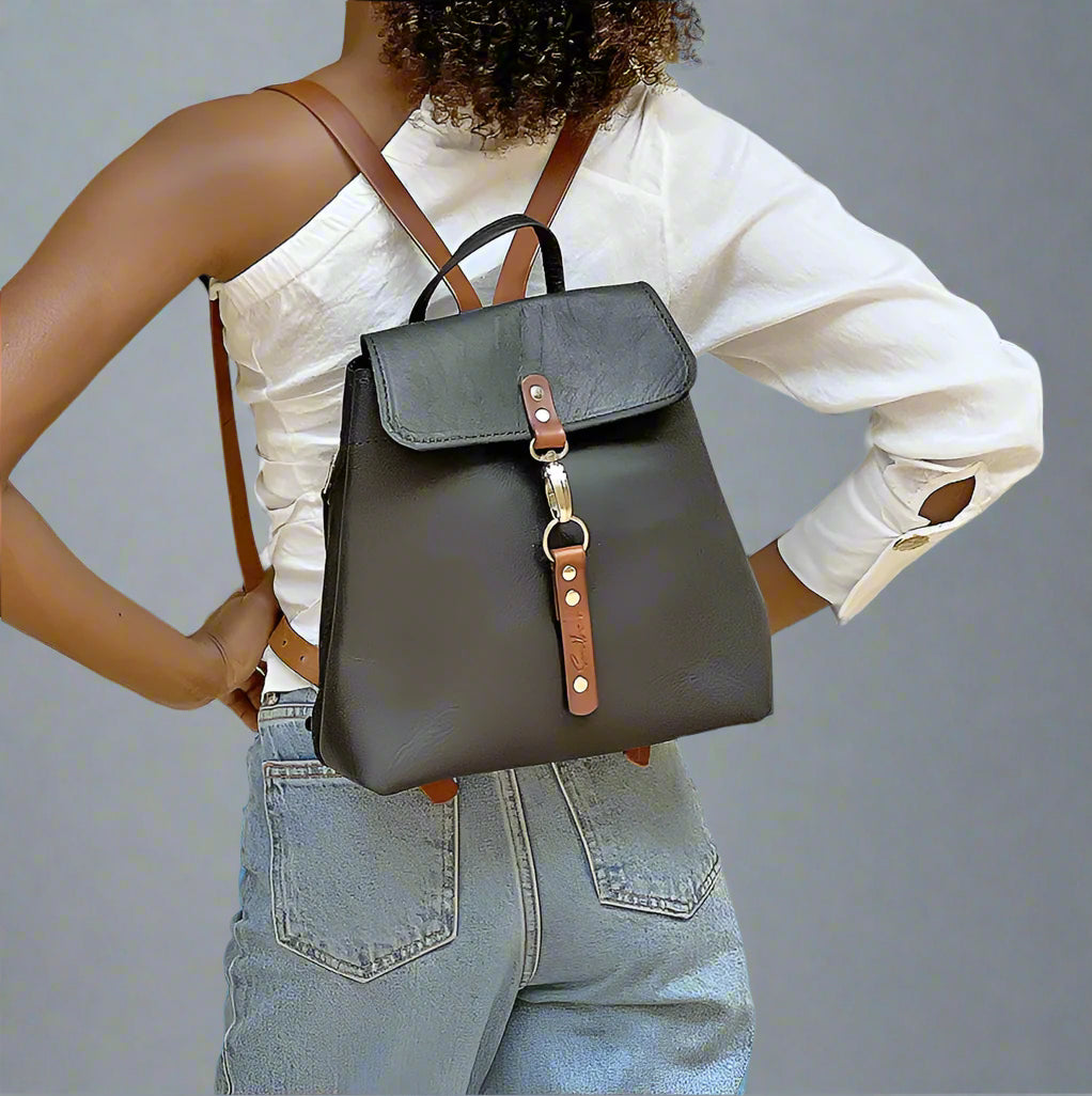 Model wearing the black and tan Smithco Leather bag pack showing the triangular shape.