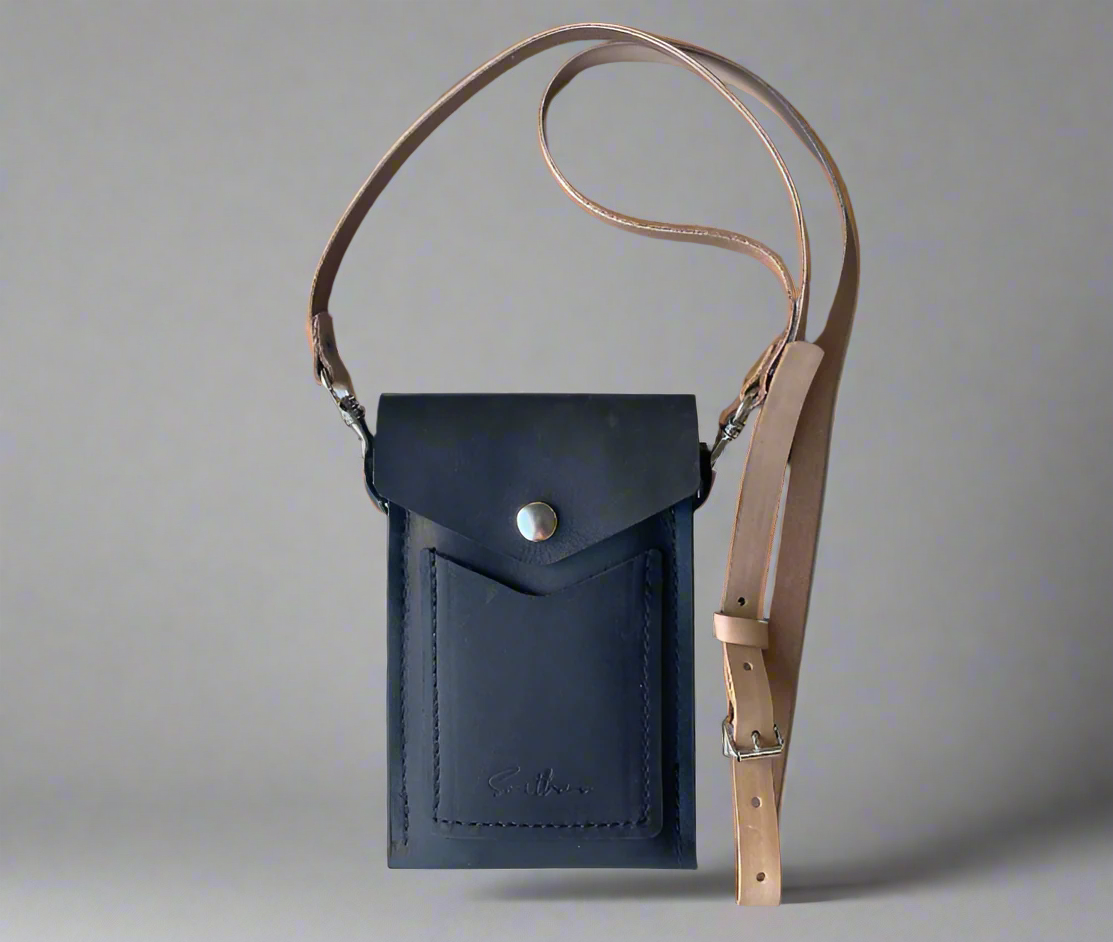 Minimal leather mini bag with secure flap closure and slim crossbody strap in black – handcrafted in South Africa
