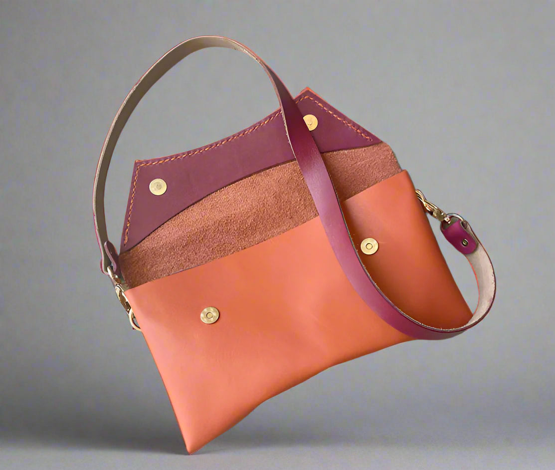 Handmade full-grain coral & rose leather Crescent Clutch Bag inner with vibrant two-toned design – versatile clutch or crossbody with adjustable strap. Perfect for stylish women, features compartments for phone and cards.