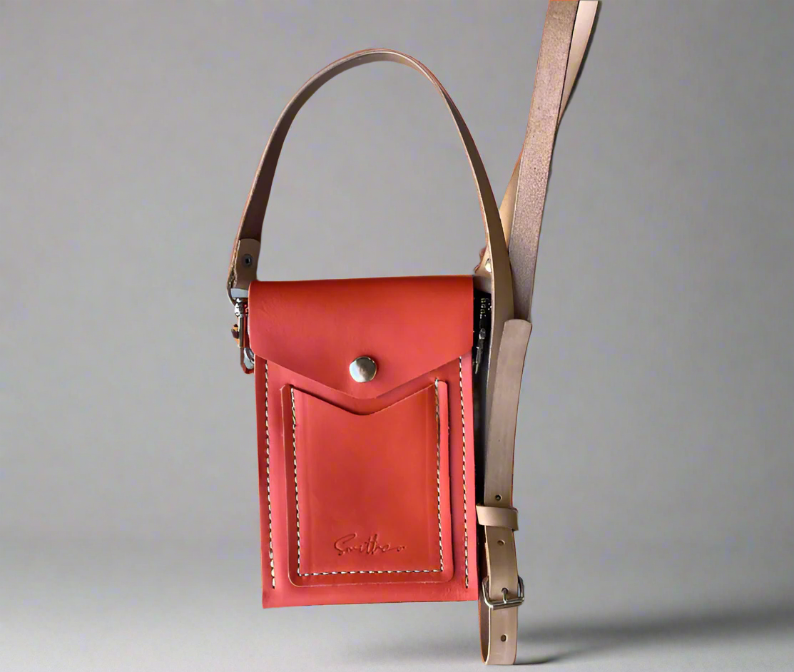 Minimal leather mini bag in coral orange with secure flap closure and slim crossbody strap – handcrafted in South Africa
Essential Mini: a lightweight leather bag designed for hands-free everyday wear