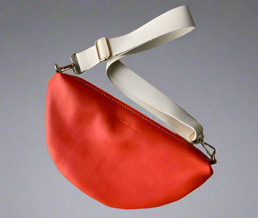 Halfmoon crossbody bag in full grain orange leather with cotton webbing strap