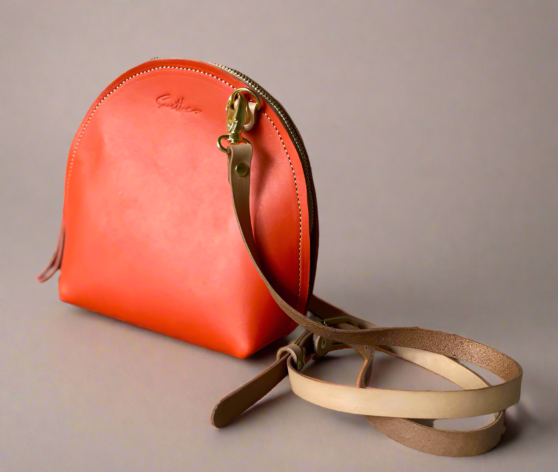 The Arc mini crossbody leather bag in coral
