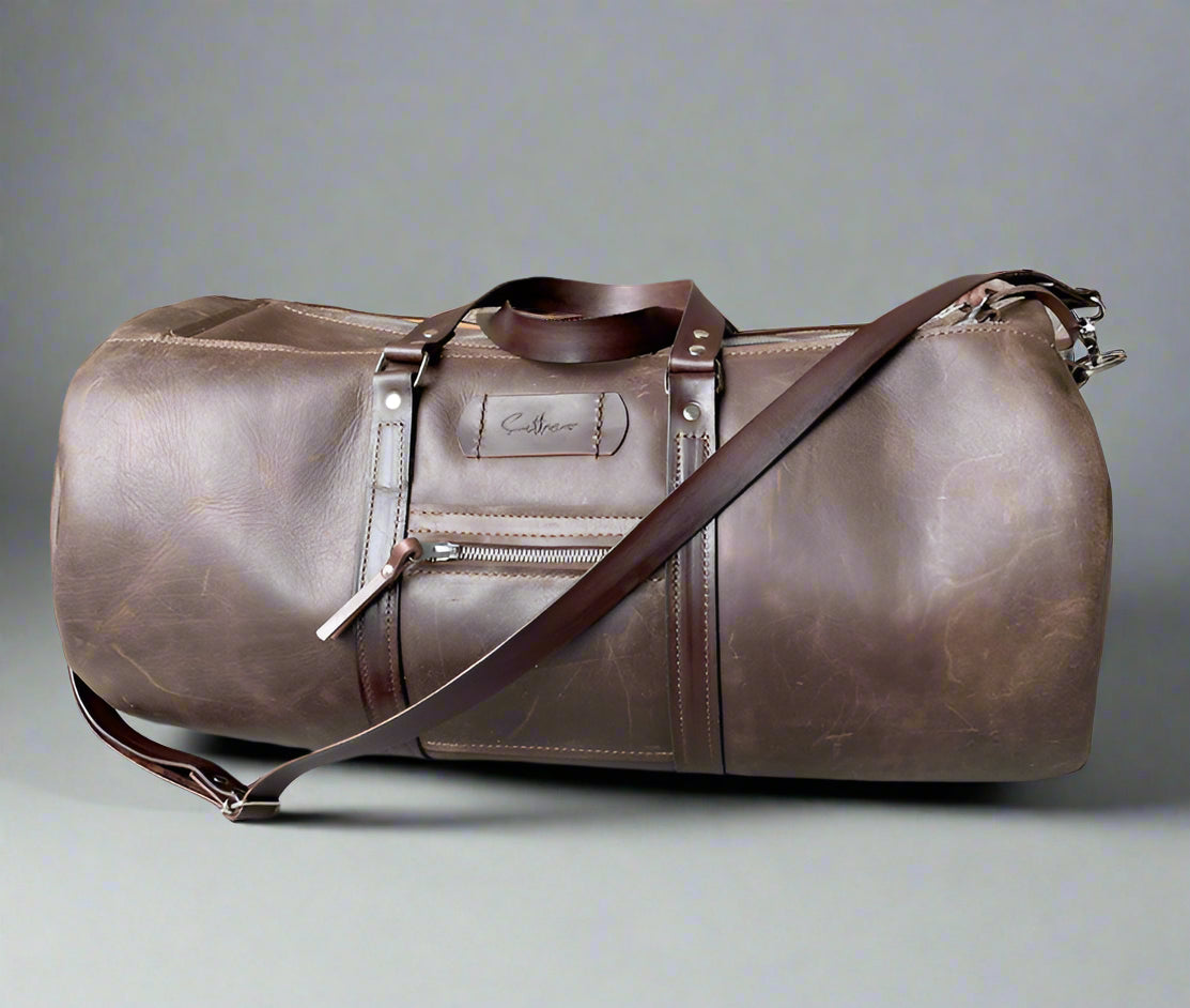 Spacious full grain leather weekend duffel bag in brown with sturdy handles and detachable strap, handmade in Cape Town