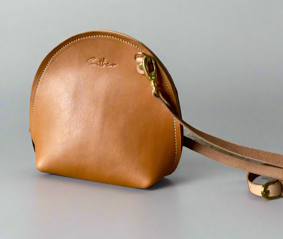 The Arc mini crossbody leather bag in tan