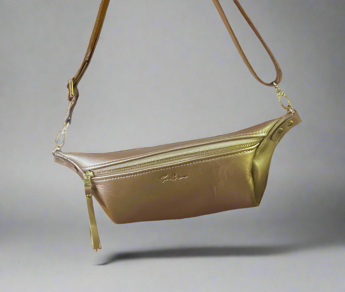 Gold full grain leather Moonsling crossbody bag with curved shape and adjustable strap, handmade in Cape Town