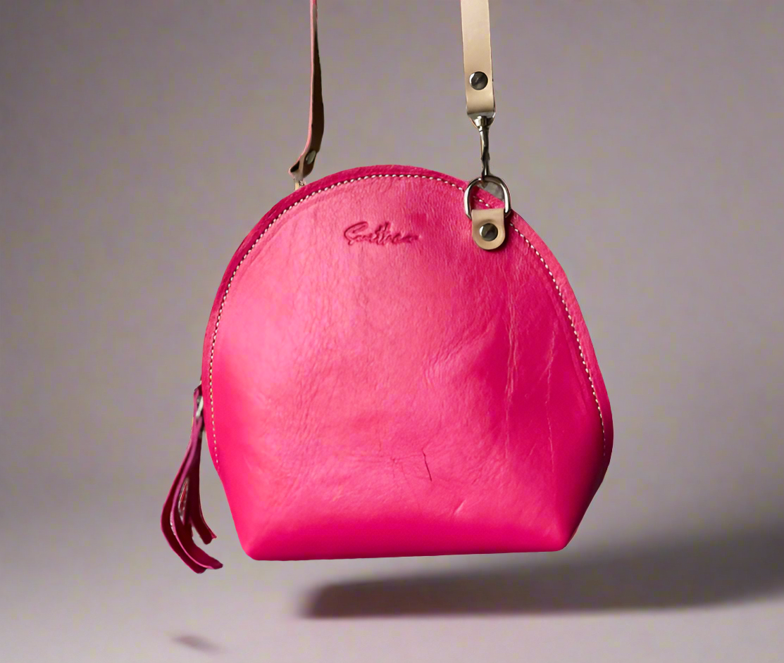 The Arc mini crossbody leather bag in hot pink