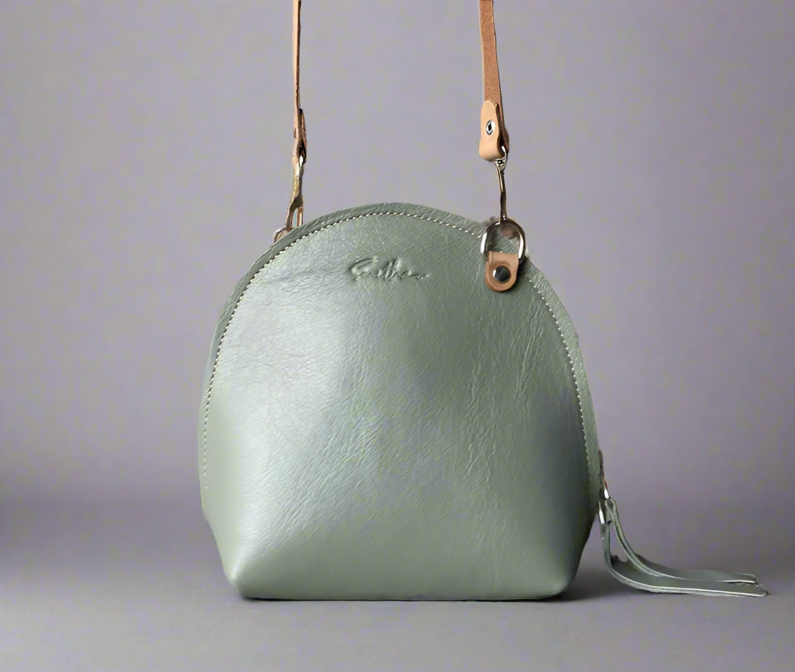The Arc mini crossbody leather bag in mint green