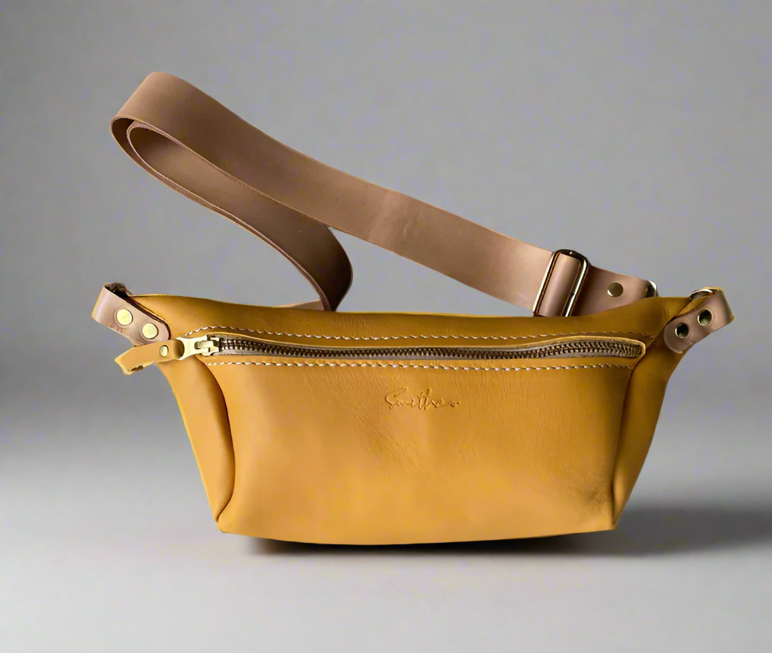 Ochre yellow gold full grain leather Moonsling crossbody bag with curved shape and adjustable strap, handmade in Cape Town