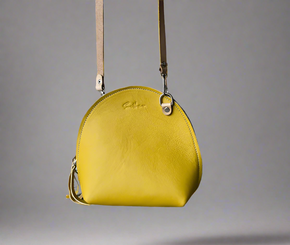 The Arc mini crossbody leather bag in Ochre