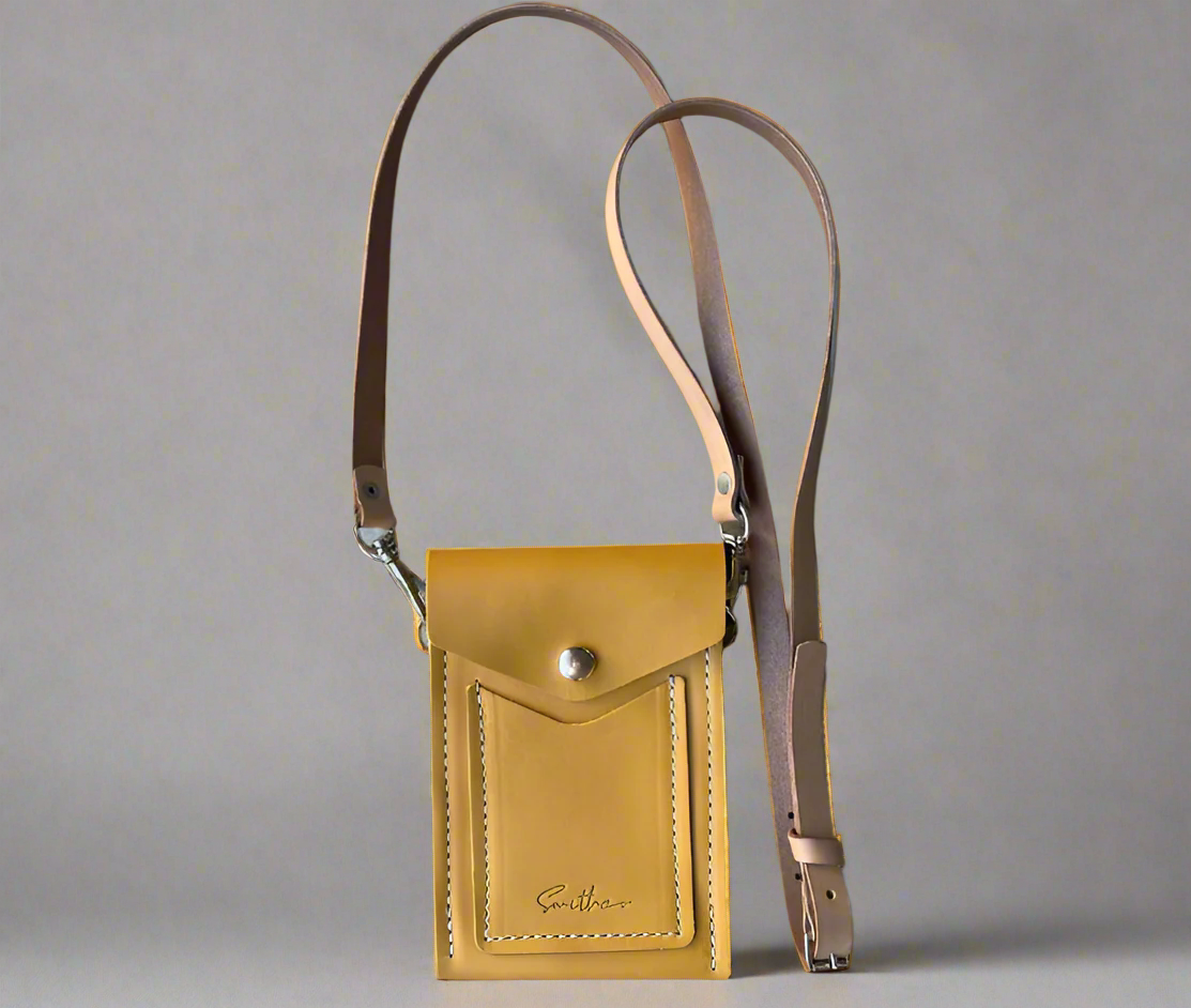 A Smithco Essential Mini: a lightweight leather bag in ochre yellow designed for hands-free everyday wear