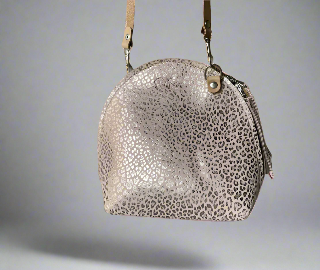 The Arc mini crossbody leather bag in pink suede leopard print