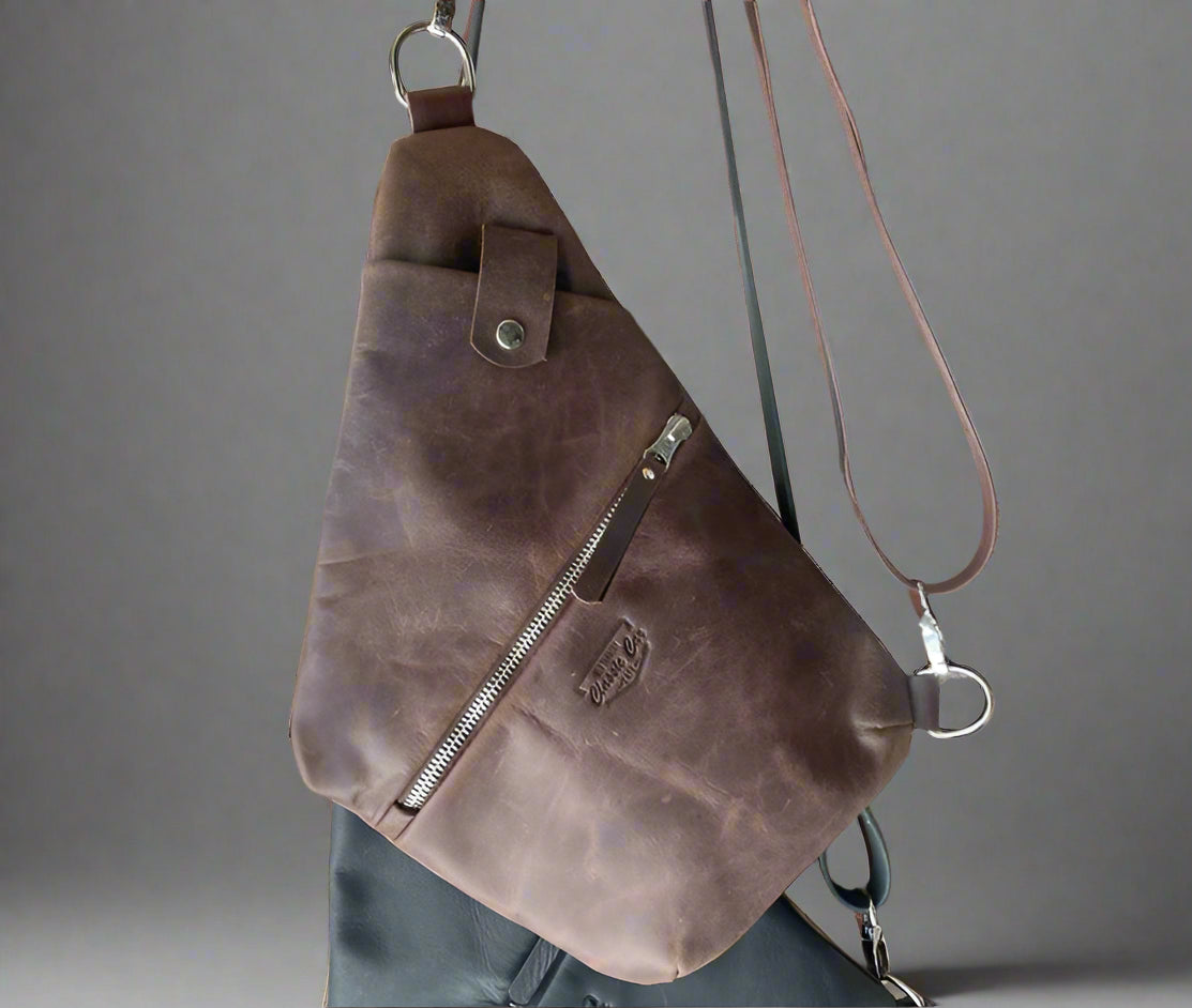 Full grain leather travel bag in body hugging style to keep your items secure. Handmade in Cape Town. Available in black and brown