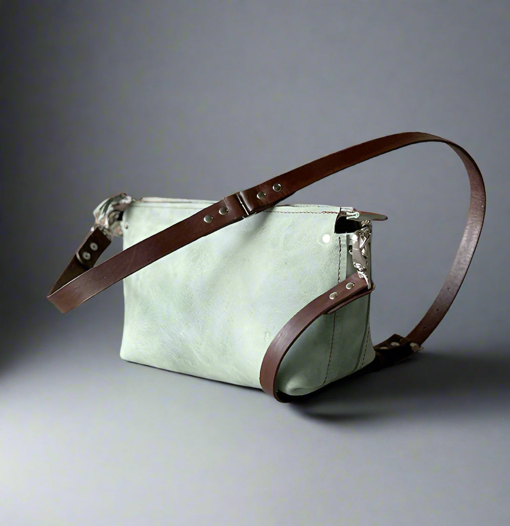 Medium-sized crossbody bag made from premium sage green & brown full-grain leather – Stylish and practical with adjustable strap for a perfect fit. Ideal for daily essentials, work, and city adventures.