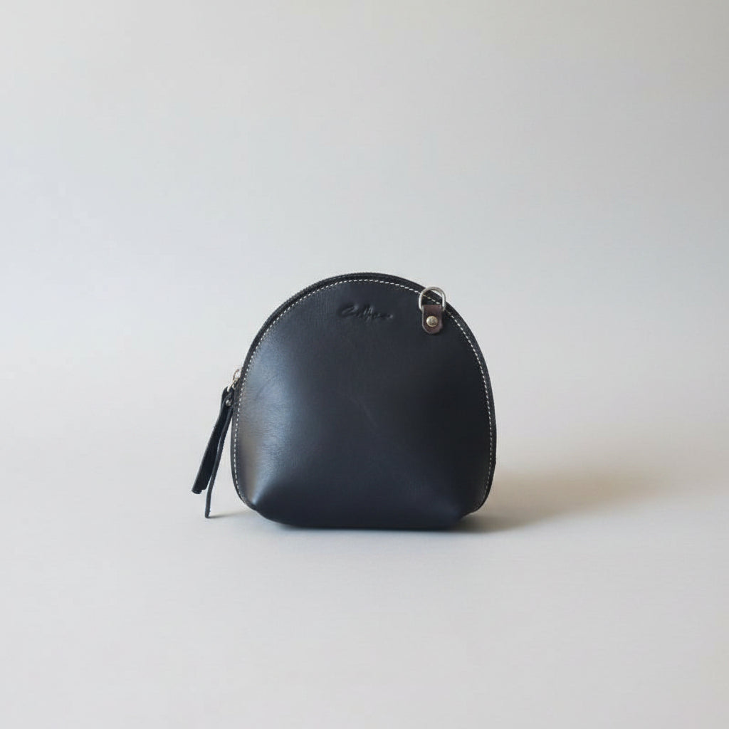 Arc shaped full grain mini bag with natural stitching
