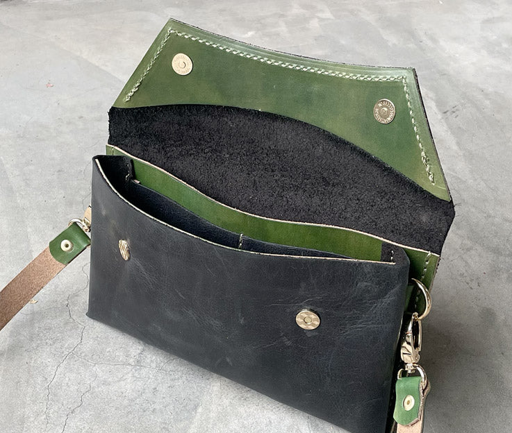 Handmade full-grain black & forest green leather Crescent Clutch Bag inner with vibrant two-toned design – versatile clutch or crossbody with adjustable strap. Perfect for stylish women, features compartments for phone and cards.