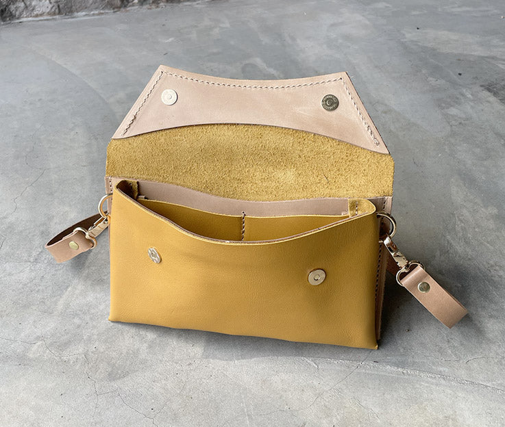 Handmade full-grain yellow leather Crescent Clutch Bag inner with muted two-toned design – versatile clutch or crossbody with adjustable strap. Perfect for stylish women, features compartments for phone and cards.