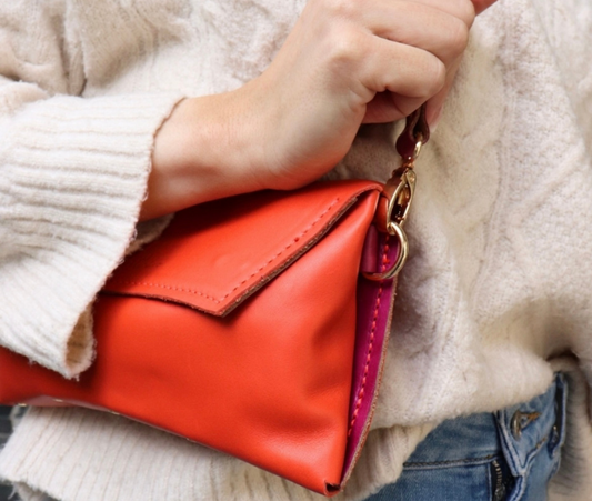 Handmade full-grain coral & rose leather Crescent Clutch Bag with vibrant two-toned design – versatile clutch or crossbody with adjustable strap. Perfect for stylish women, features compartments for phone and cards.