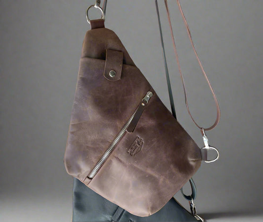 Full grain leather travel bag in body hugging style to keep your items secure. Handmade in Cape Town. Available in black and brown