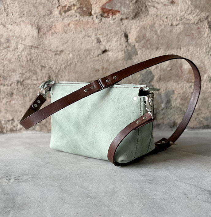 Medium-sized crossbody bag made from premium sage green & brown full-grain leather – Stylish and practical with adjustable strap for a perfect fit. Ideal for daily essentials, work, and city adventures.